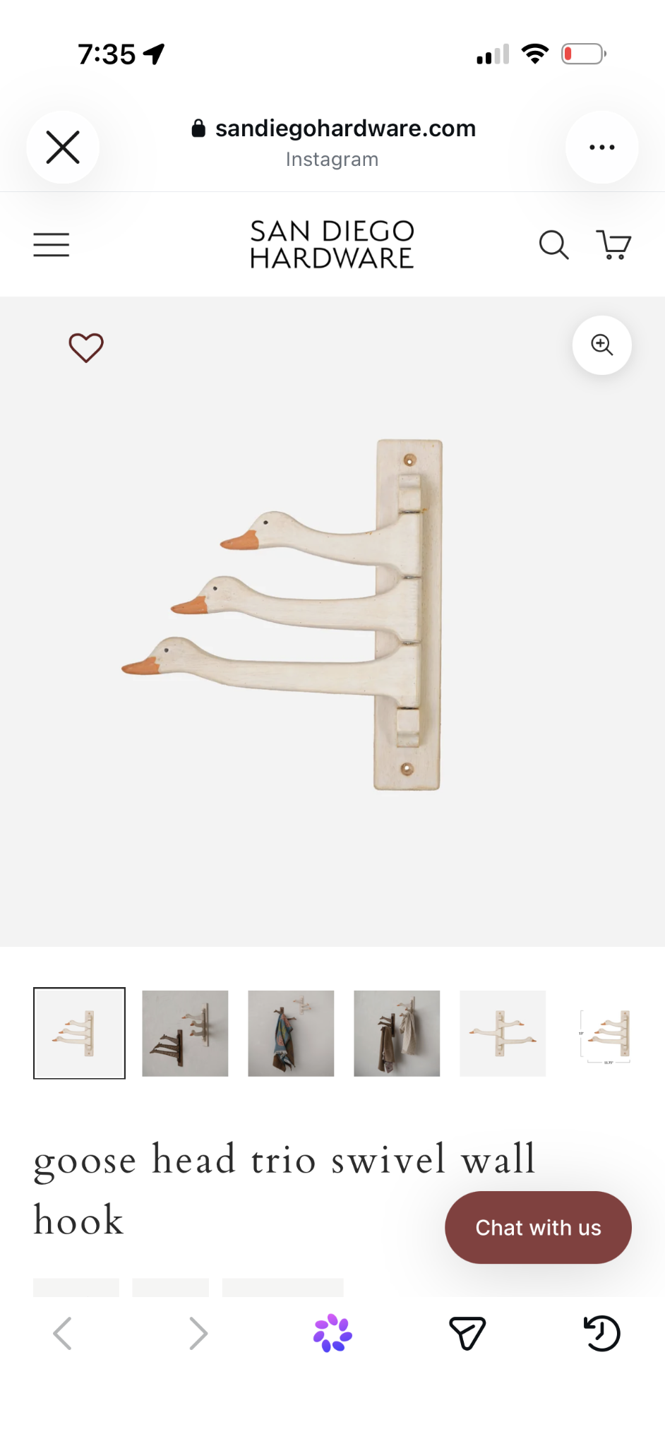 Three cream goose-head swivel wall hooks on a brass-toned wall plate.